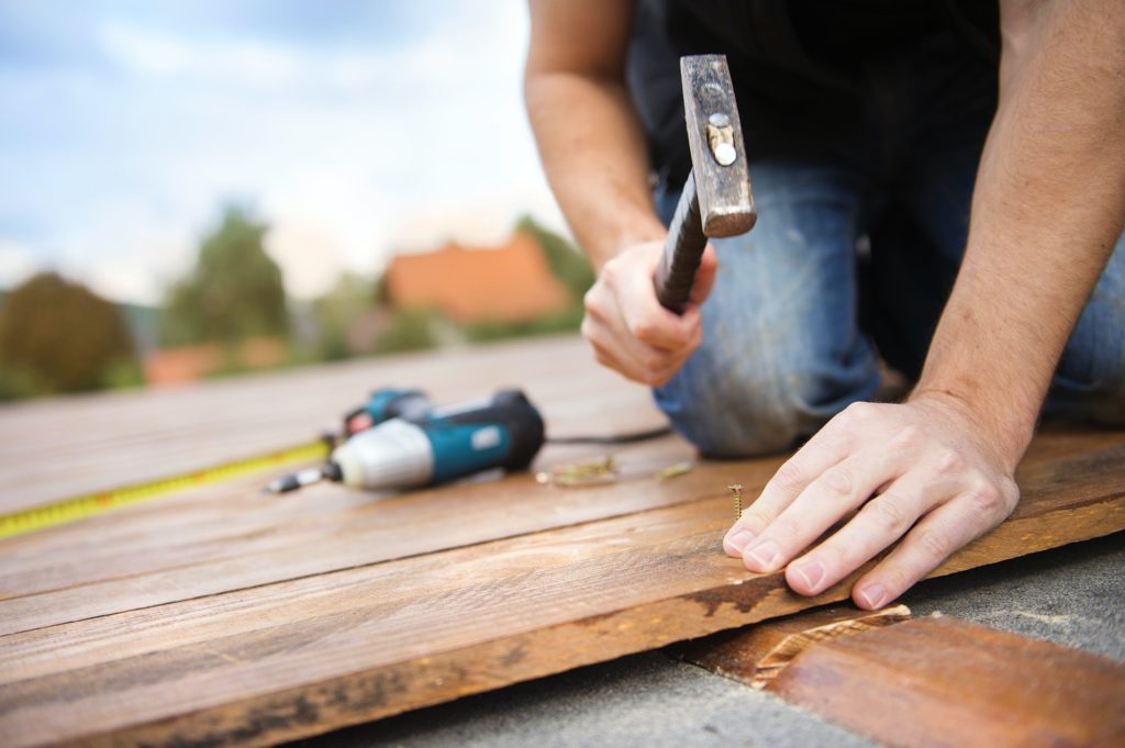 Handyman installing wooden flooring